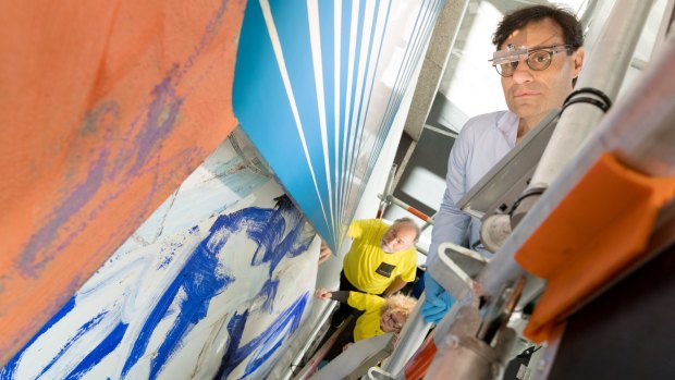 Stellar opportunity: Conservators David Stein (right) with Julia Sharp and Stewart Laidler tackle the ravages of pollution on the Frank Stella artworks  in the foyer of Harry Seidler's landmark building.