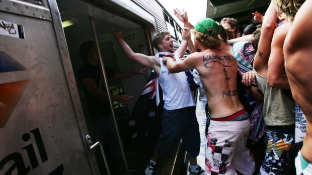 Brent Lohman, wearing the flag, exits a train carriage after taking part in an assault.