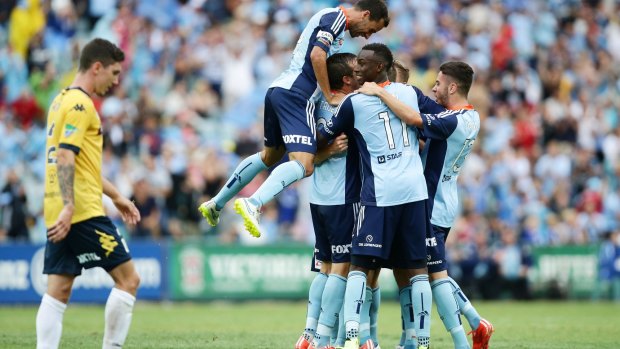 Joy and despair: Sydney FC players celebrate, while the Mariners were left to rue missed opportunities.