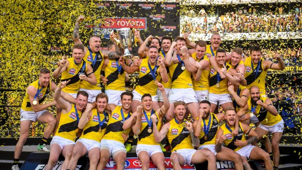 Rance and the Tigers celebrate with the premiership cup.
