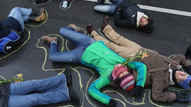 Grim reminder: Demonstrators  on the ground in a mock  protest over the shooting death of Michael Brown.