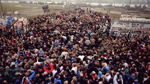 East and West Berliners meet after the Berlin Wall was torn down at Potsdamer Platz to make way for a new border crossing in November 1989.