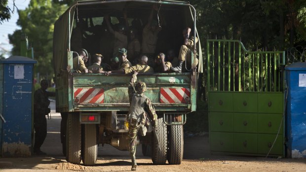 Soldiers from the Kenya Defence Forces enter the college compound on Friday. 