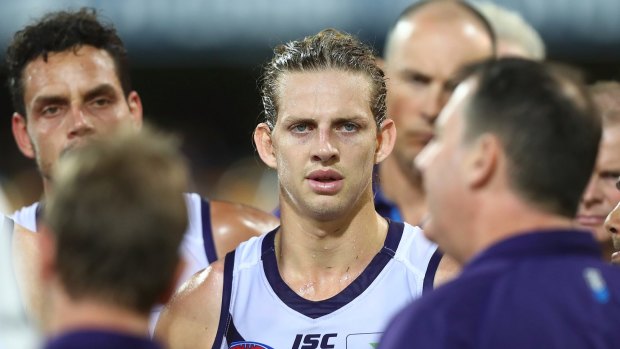 Dockers skipper Nat Fyfe looks on while coach Ross Lyon talks to players.