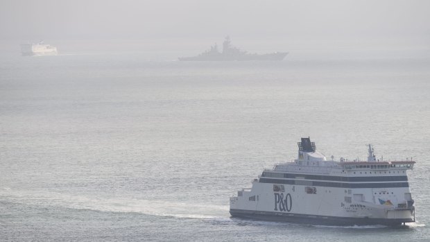 A Russian Naval vessel passes between two car ferries in the English Channel last week.