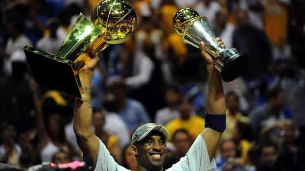 Star: Kobe Bryant holds up the Larry O'Brien trophy and the Bill Russell MVP trophy after the Lakers defeated the Orlando Magic 99-86 in Game Five of the 2009 NBA Finals.