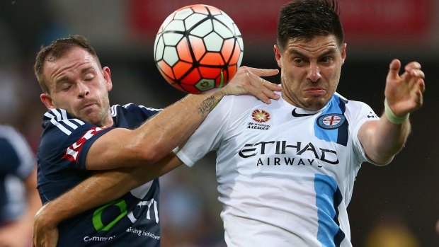 Leigh Broxham of the Victory and Bruno Fornaroli of the City compete for the ball.