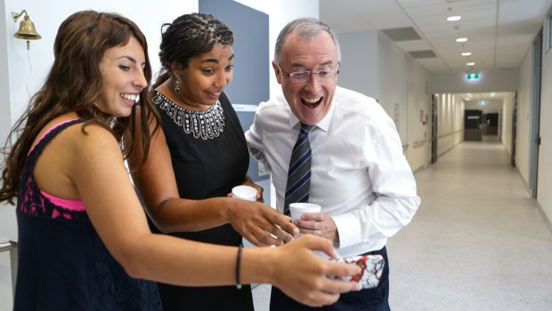 Jaida, Dr Antoinette Anazodo and Professor William Ledger watch a video of the song that was performed by medical staff and friends after Jaida's final cancer treatment. 