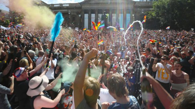 Hundreds celebrate the 'yes' vote to same-sex marriage outside Melbourne's State Library.