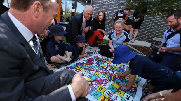 "Who's winning?": children at the centre play Snakes and Ladders.