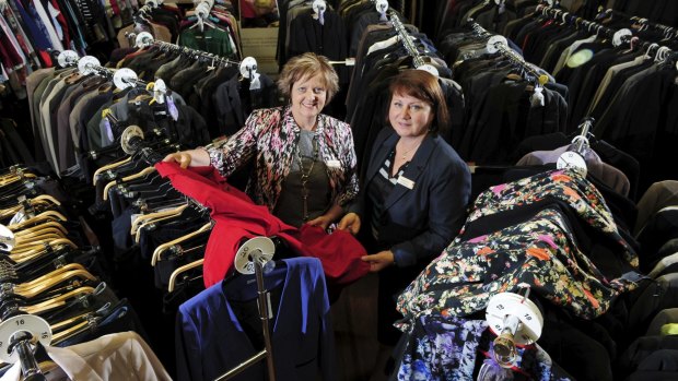 Kim Bool, director of social programs with not-for-profit organisation Communities@ at Work, left, with chief executive Lynne Harwood, surrounded by clothing for sale. 