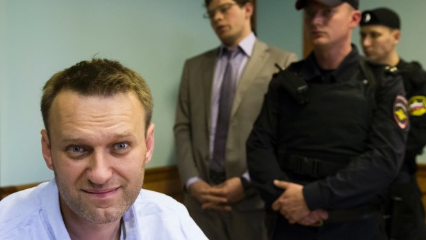 Russian opposition leader Alexei Navalny, left, sits during a hearing over his arrest in Moscow on June 16.