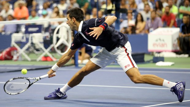 Novak Djokovic returns a shot to Feliciano Lopez.