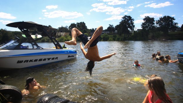 Children hit the Nepean River at Penrith to get some relief from the heat.