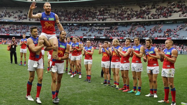 Sad farewell: Daniel Merrett is chaired off after playing his 200th and final match.