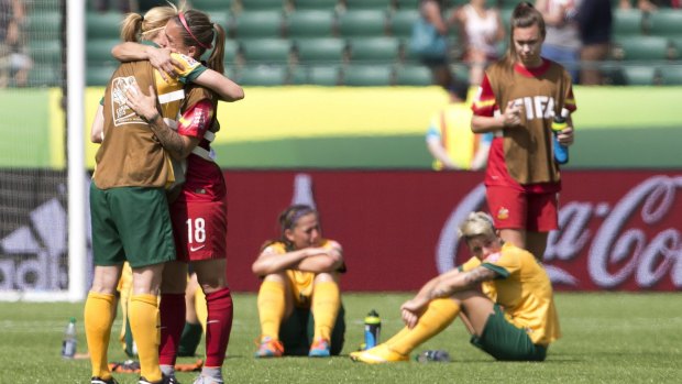 Agony: Australia goalkeeper Melissa Barbieri is hugged by a teammate after the Matildas lost to Japan at the World Cup.