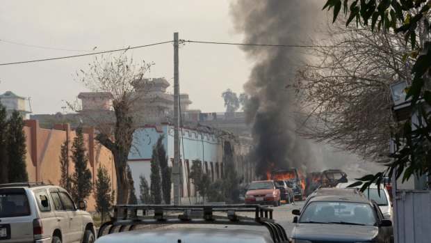 Vehicles burn after the second blast, from a parked car, in Jalalabad on Wednesday.