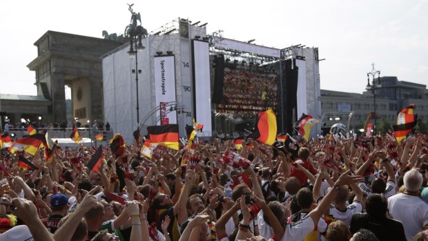 The party continues: German fans celebrate the return of their team in Berlin on Tuesday.