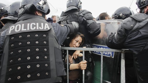 Slovenian police let a refugee cross the border at  Rigonce, Slovenia, on Saturday.