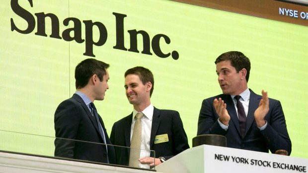 Snapchat co-founders Bobby Murphy, left, and CEO Evan Spiegel, center, ring the opening bell at the New York Stock Exchange on March 2.