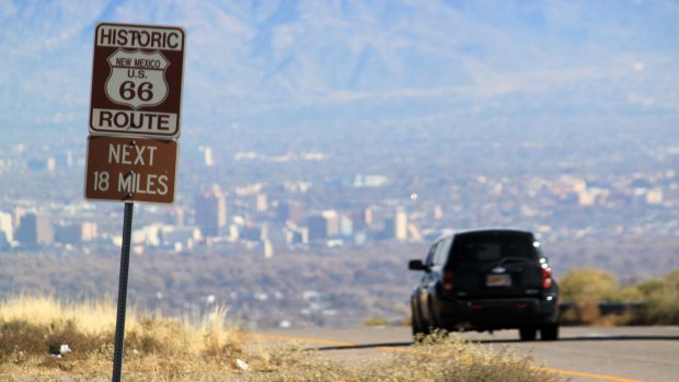 A car travels down historic Route 66 toward Albuquerque, New Mexico. 