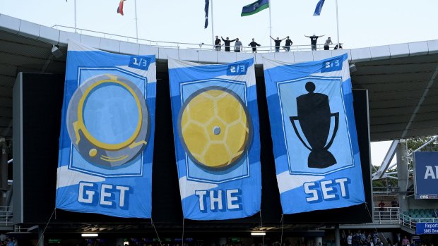 Got it: Sydney FC fans unfurl banners before the final.