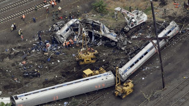 Emergency personnel work at the scene of the deadly Amtrak train derailment.