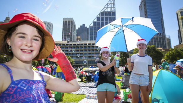 Clare Barber, 8, Isabel Martin, 10, and Juliette Martin, 14, at Carols in the Domain.