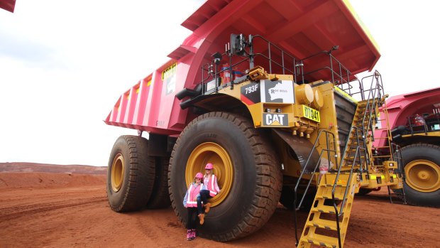 Gina Rinehart and daughter Ginia on a pink mining truck at the Roy Hill iron ore mine.