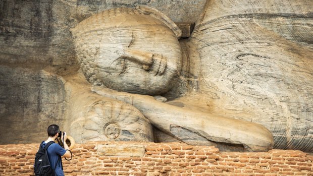 The beautiful statue of the Reclining Buddha carved in stone at the Gal Vihara, a rock temple situated in the ancient city of Polonnaruwa in North Central Province, Sri Lanka.