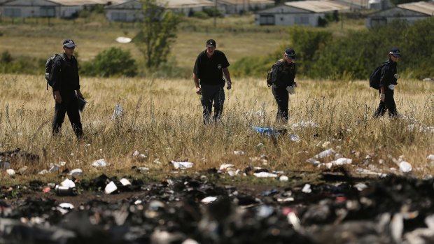 Australian Federal Police and their Dutch counterparts searching at the MH17 crash site.