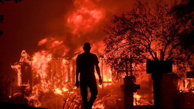 Homes caught alight with frightening speed after wildfires whipped by powerful winds tore through California's wine country.