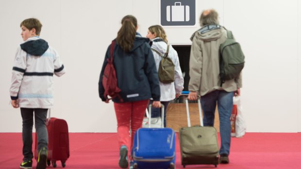 The first passengers arrive at the temporarily check-in terminal at Brussels Airport, in Zaventem, Belgium on Sunday.