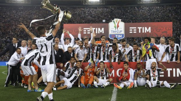 Juventus' players celebrate with the trophy.