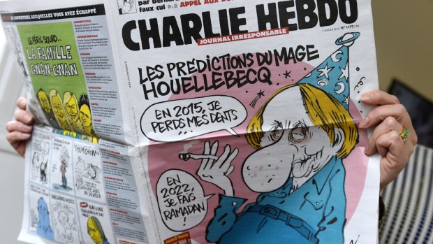 Reading the latest issue of the French satirical newspaper Charlie Hebdo in Paris.