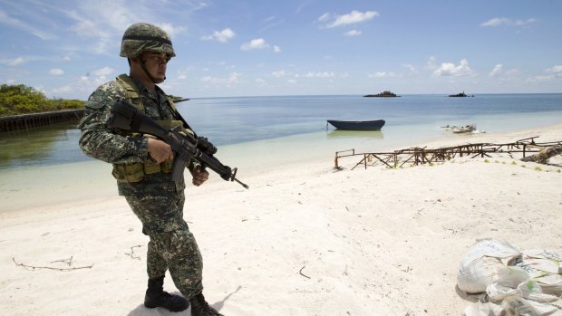 A Filipino soldier patrols the shore of Pagasa Island in the Spratly Islands in May.
