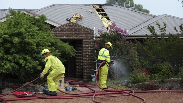 Mopping up: A home in Menzel Crescent, Dunlop, was struck by lightning.