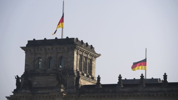 Flags flutter half-mast on top of the Reichstag building, the seat of the German lower house of parliament, in Berlin on Wednesday.