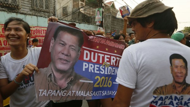 Duterte supporters hold a campaign banner in the capital Manila. 