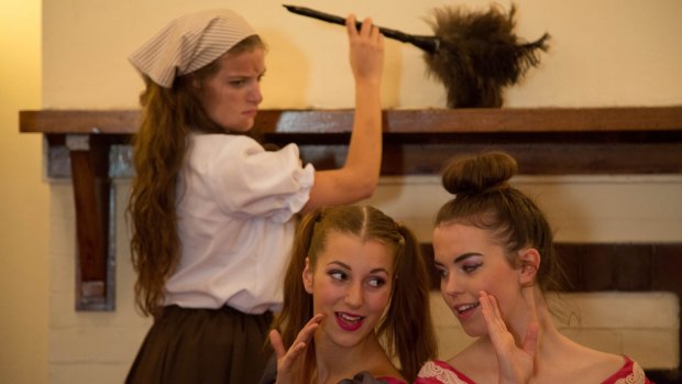 (From left) Cinderella (Adellene Fitzsimmons) is put to work by stepsisters Joy (Risa Craig) and Grace (Holly Ross).