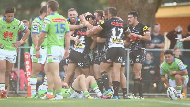 Tyrone Peachey of the Panthers celebrates a try with his teammates.