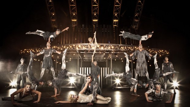 Performers in Quidam's banquine act with the telepherique in the background.