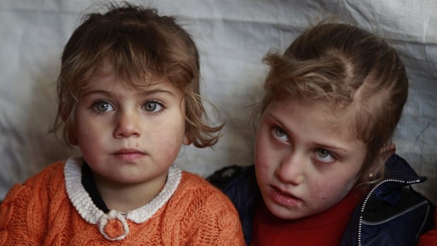 Eman al-Aqraa, 8, right, and her sister Fatima, 4, at a Syrian refugee camp in Lebanon.