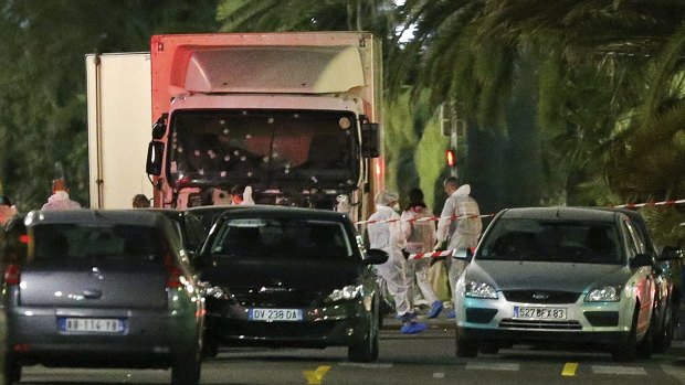 Police surround the truck that slammed into a Bastille Day crowd in Nice on Thursday.