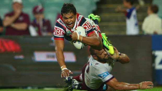 Flying high: Latrell Mitchell scores against Manly.