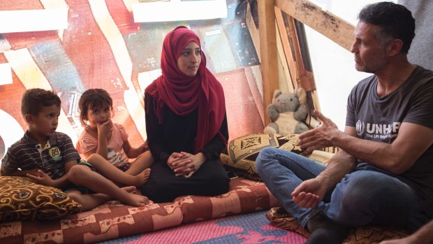 Hosseini talks to Syrian refugee Noura, her son, Ziad, and her daughter, Rawa who are hoping to be re-united with her husband, Mohamad.
