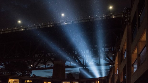 Protesters shine light onto the sails of the Opera House during the launch of the Everest barrier draw.