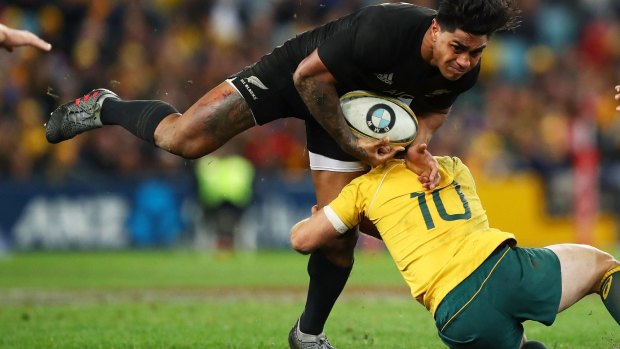 Hard man to stop: Malakai Fekitoa steamrolls Bernard Foley.