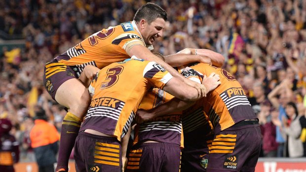 On a roll: Broncos players celebrate at the final whistle.