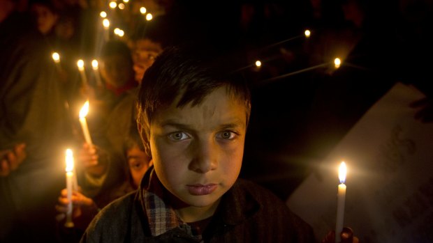Kashmiri Shiite Muslim boys hold candles during a protest against Saudi Arabia in Srinagar in Indian-controlled Kashmir.